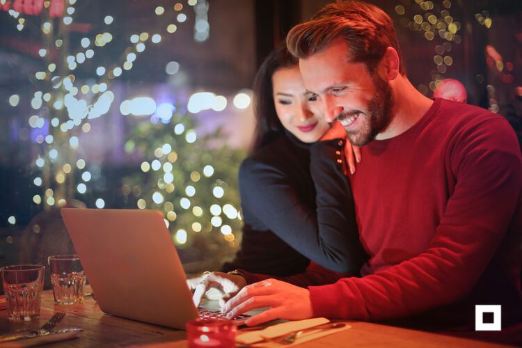 Couple browsing online with holiday background