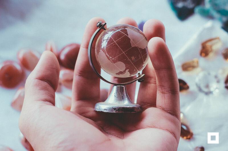 Hand holding globe