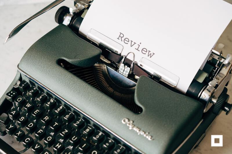Typewriter with paper that reads review