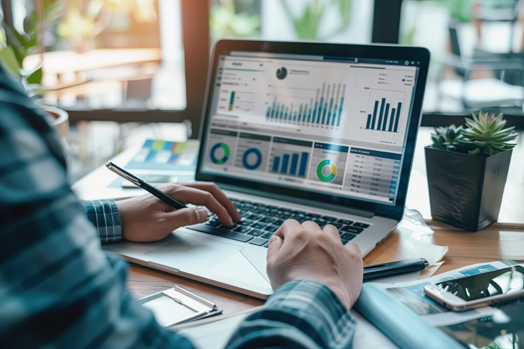 Focused professional developing a Digital Marketing strategy on a computer, analyzing data to drive targeted traffic, increase conversions, and improve ROI.