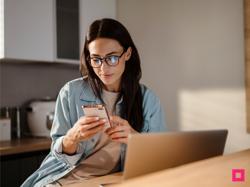 Woman browsing on her smartphone, illustrating Engaging Consumers through targeted mobile ads and personalized digital content experiences.