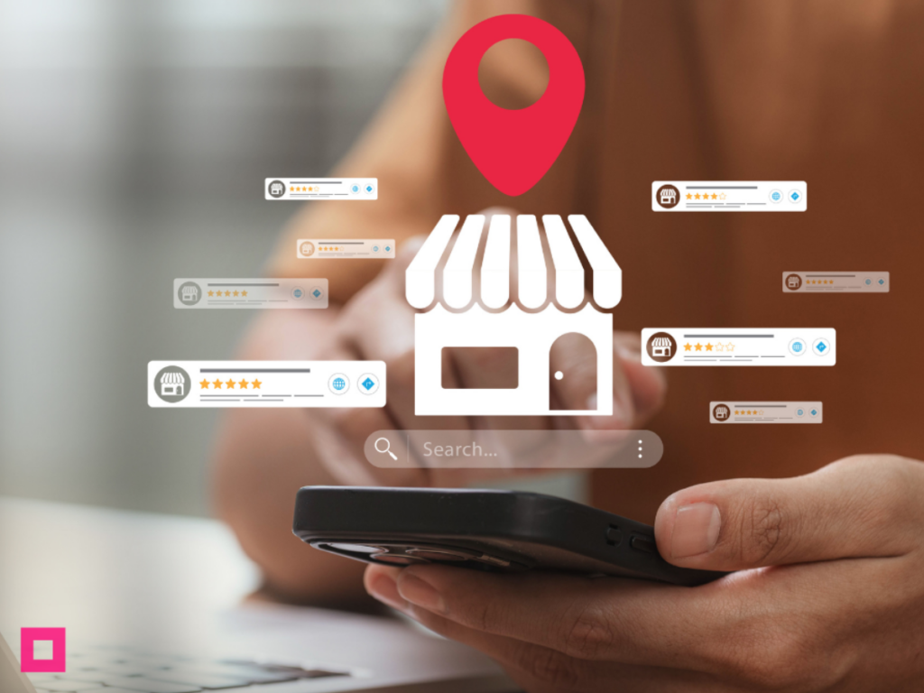 f1 | Impressions Agency An illustration showing how to reach local audience segments through a Google Business Profile optimization. A person holds a smartphone with a stylized local storefront icon, a bright red map pin, a search bar, and multiple customer review pop-ups with star ratings hovering above it.